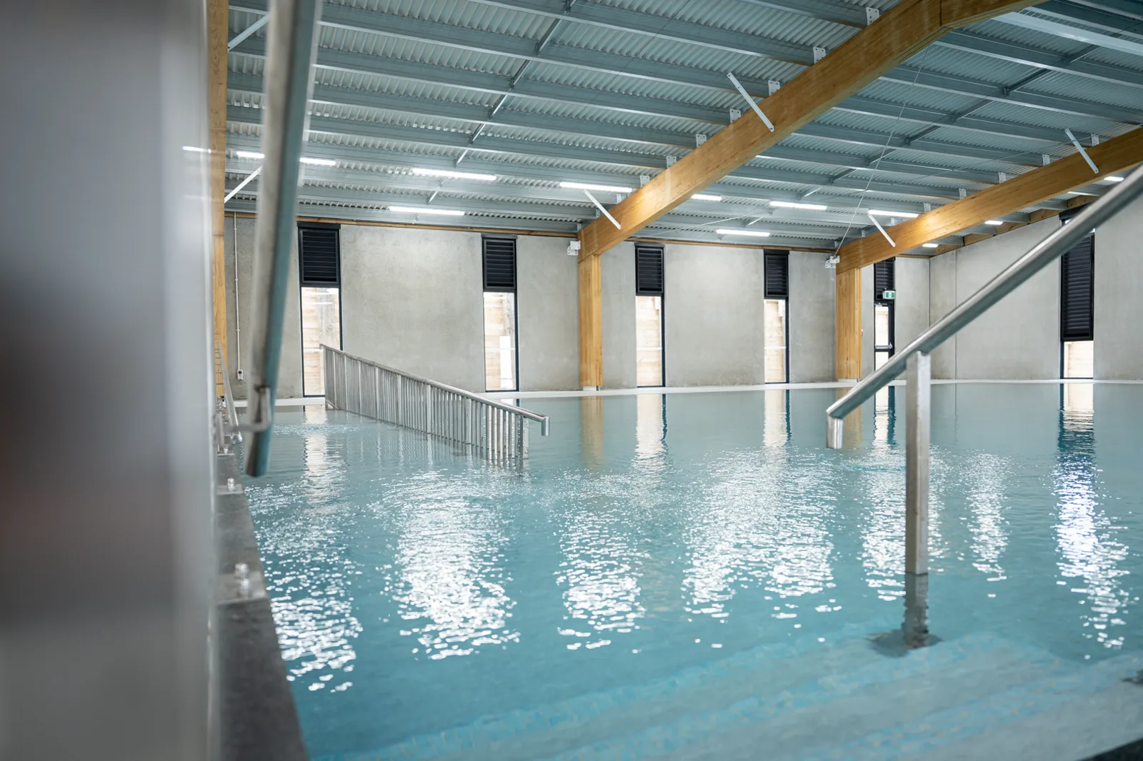 Accessible graded ramp and handrail leading into the hydrotherapy pool