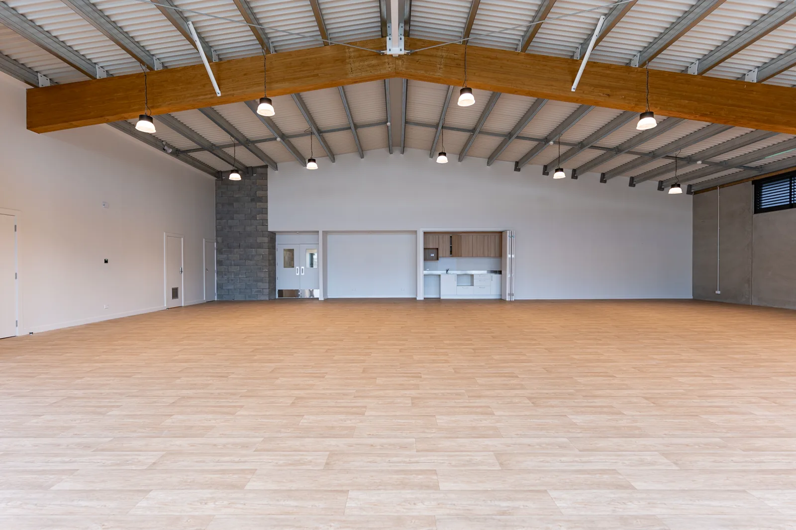 Multipurpose hall with servery kitchen and feature stone wall