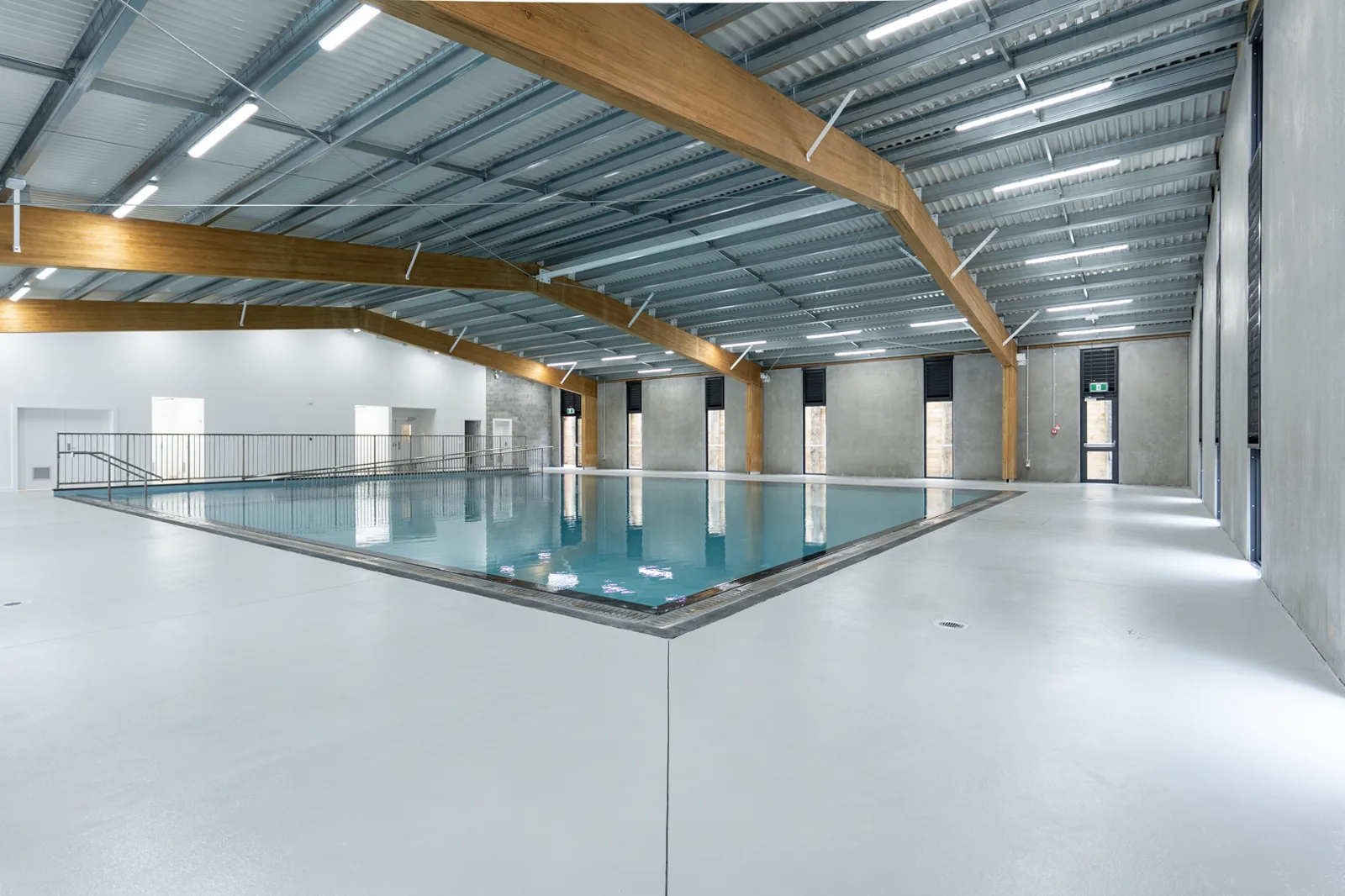 Hydrotherapy pool seen across the polished concrete concourse