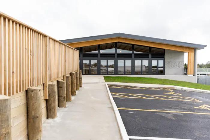 Entry path with timber pole retaining wall